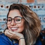 Closeup Photo of Smiling Woman Wearing Blue Denim Jacket